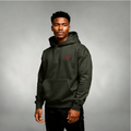 Man wearing a green hoodie with a red logo on a gray background