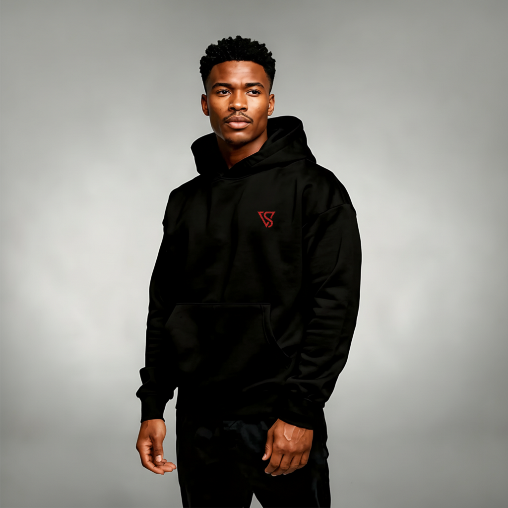 Man wearing a black hoodie with a red logo on a gray background