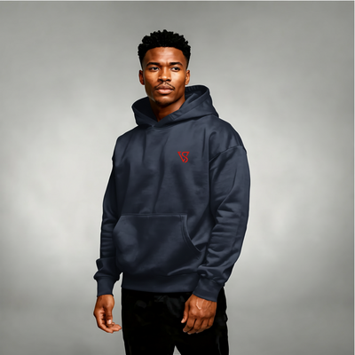 Man wearing a navy blue hoodie with a red logo on a gray background