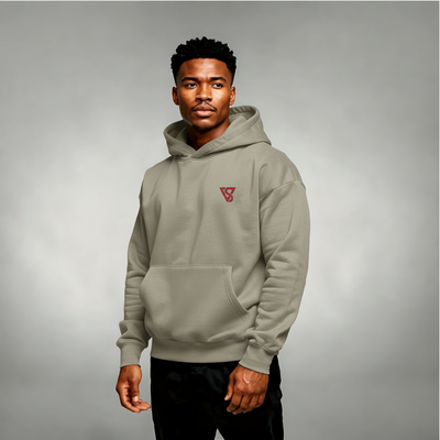 Man wearing a gray hoodie with a red logo on a gray background