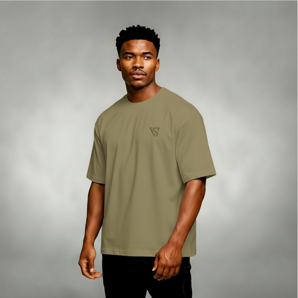 Man wearing a green t-shirt with a logo on a gray background