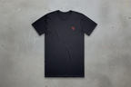 Black t-shirt with a red logo on a conrete background