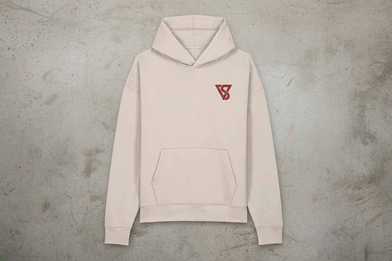 Beige hoodie with a red logo on a gray concrete background