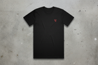 Black t-shirt with a red logo on a concrete background