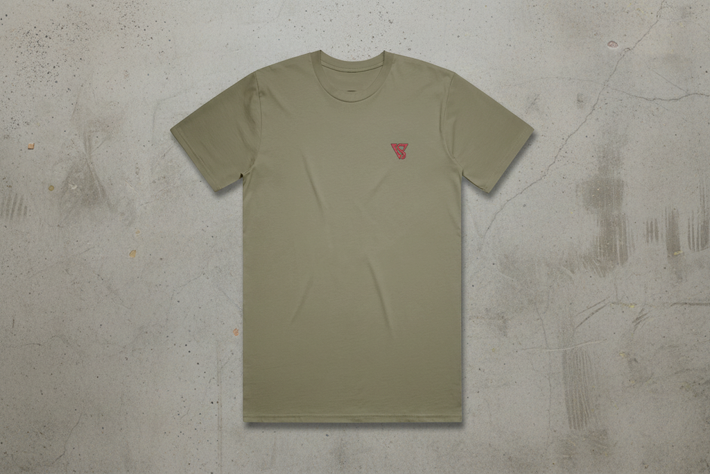 Olive green t-shirt with a small red logo on a concrete background