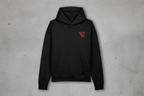 Black hoodie with a red logo on a gray concrete background